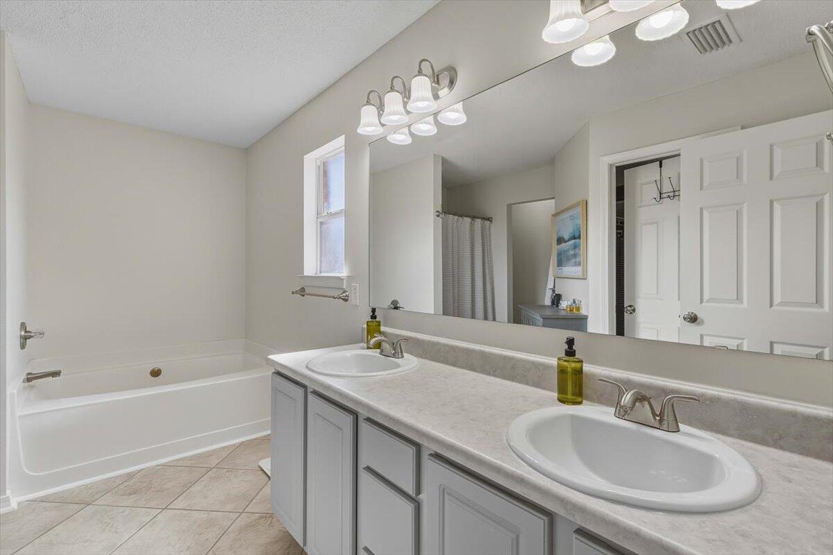 486 Jillian Drive Crestview, FL 32536 - Photo 17 of 44 a bathroom with a sink double vanity granite tub and a mirror