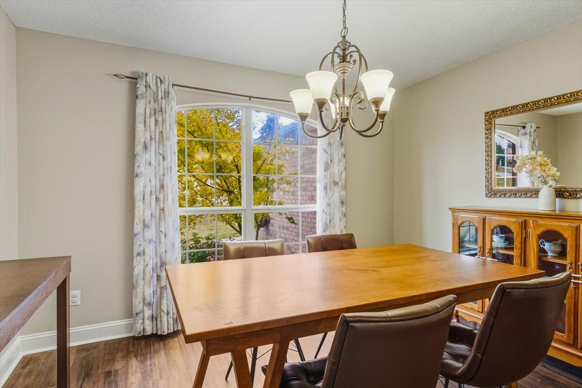 486 Jillian Drive Crestview, FL 32536 - Photo 22 of 44 a view of a dining room with furniture wooden floor and chandelier
