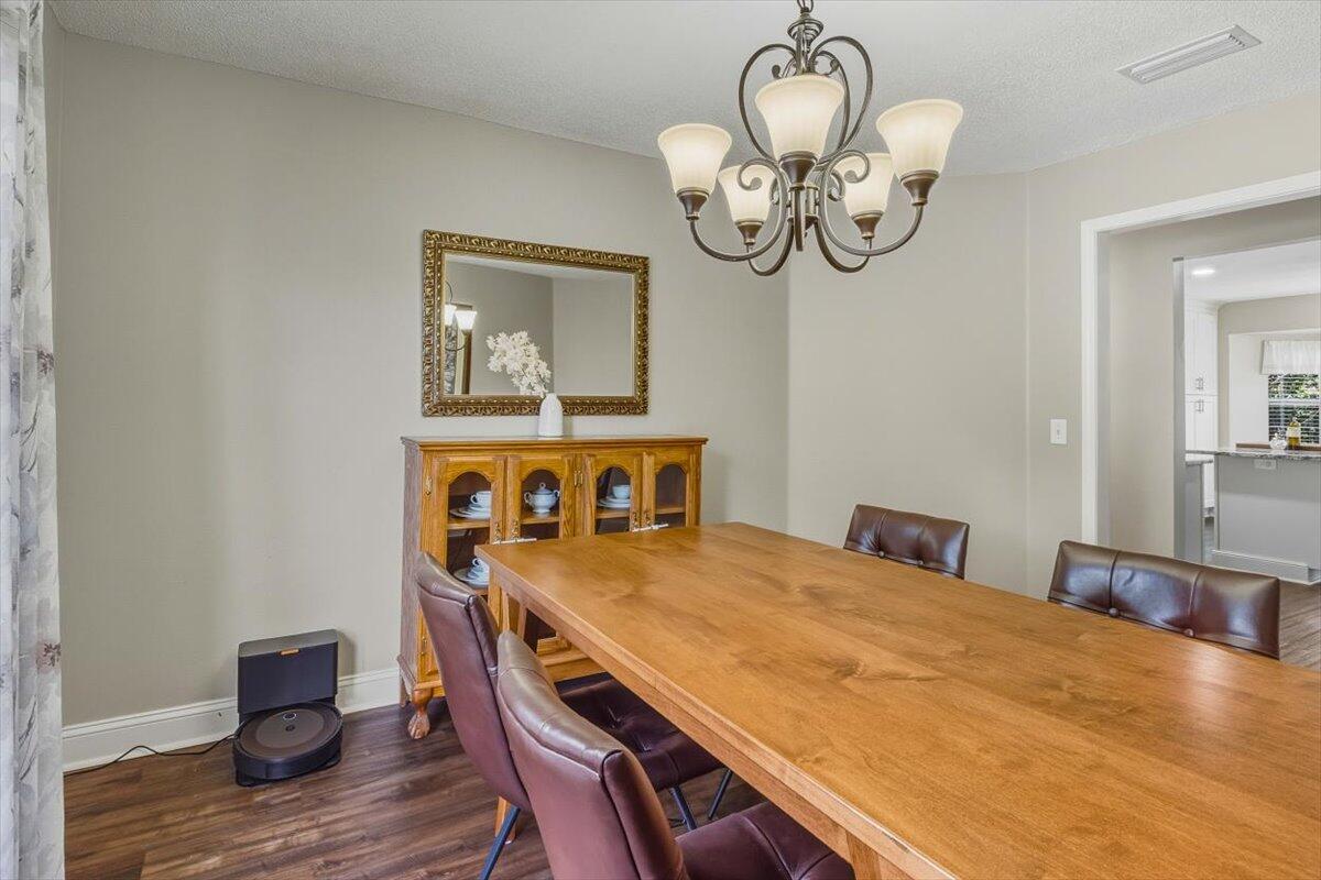 486 Jillian Drive Crestview, FL 32536 - Photo 23 of 44 a bedroom with a bed and a chandelier