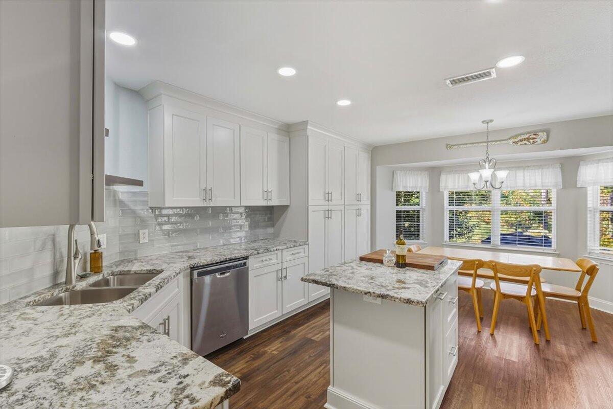 486 Jillian Drive Crestview, FL 32536 - Photo 25 of 44 a kitchen with stainless steel appliances granite countertop sink stove and wooden cabinets