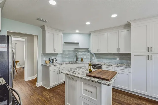 a kitchen with a sink stove and cabinets