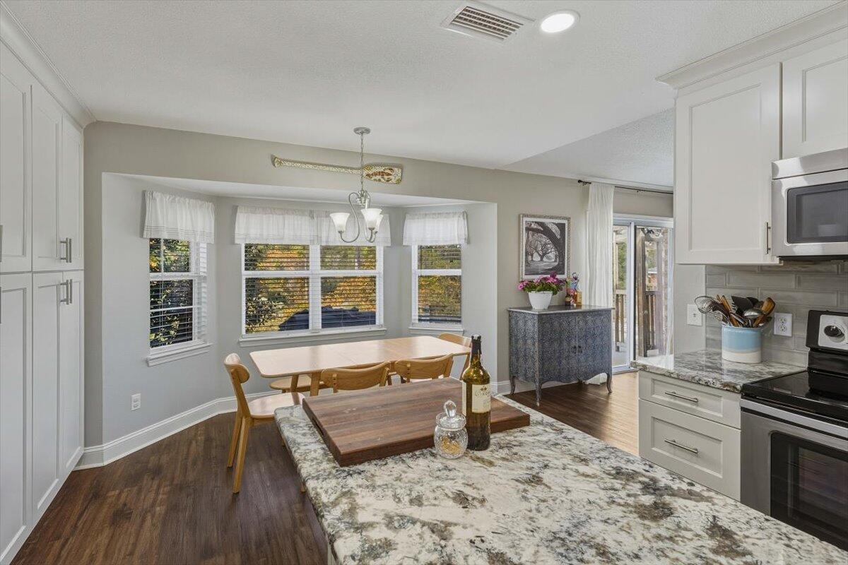 486 Jillian Drive Crestview, FL 32536 - Photo 28 of 44 a large kitchen with a table and chairs in it