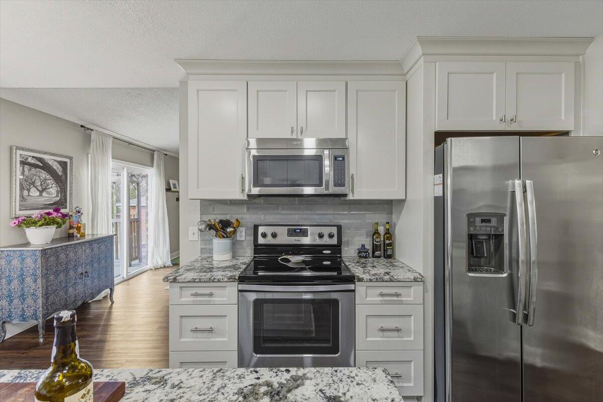 486 Jillian Drive Crestview, FL 32536 - Photo 29 of 44 a kitchen with stainless steel appliances granite countertop a stove a refrigerator and a microwave
