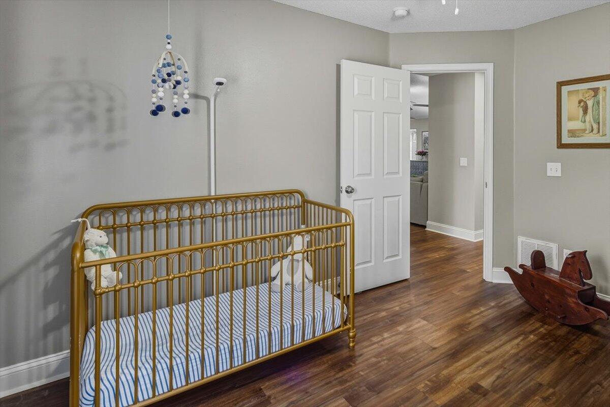 486 Jillian Drive Crestview, FL 32536 - Photo 35 of 44 a view of bedroom with furniture and wooden floor