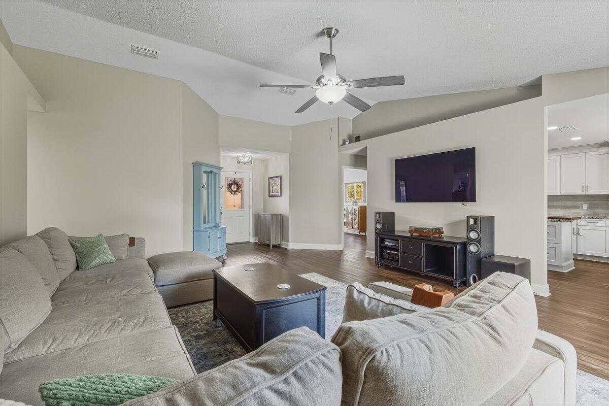 486 Jillian Drive Crestview, FL 32536 - Photo 6 of 44 a living room with furniture a flat screen tv and kitchen view