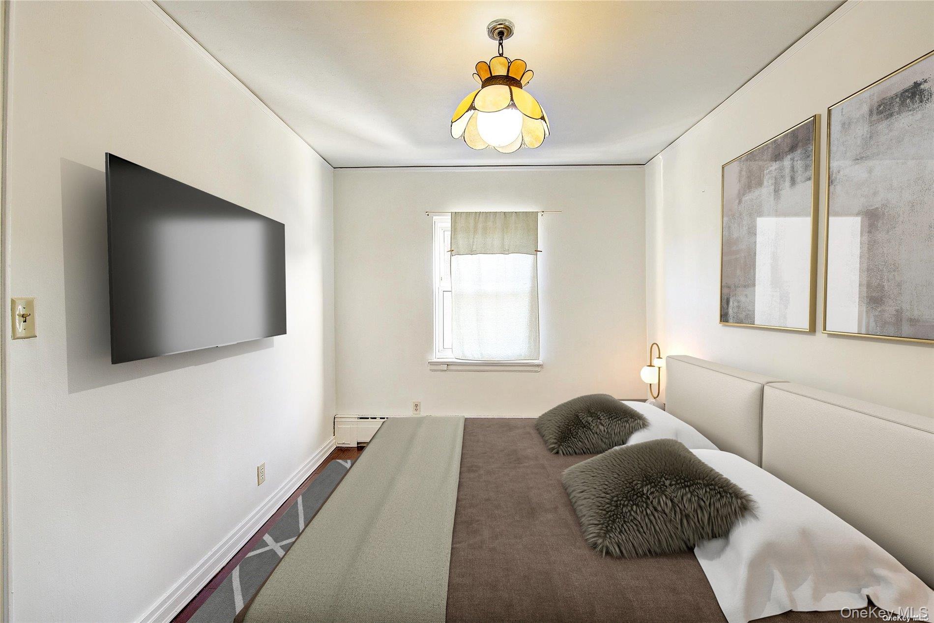 102-20 63rd Road Queens, NY 11375 - Photo 11 of 26 a bedroom with furniture and a flat screen tv