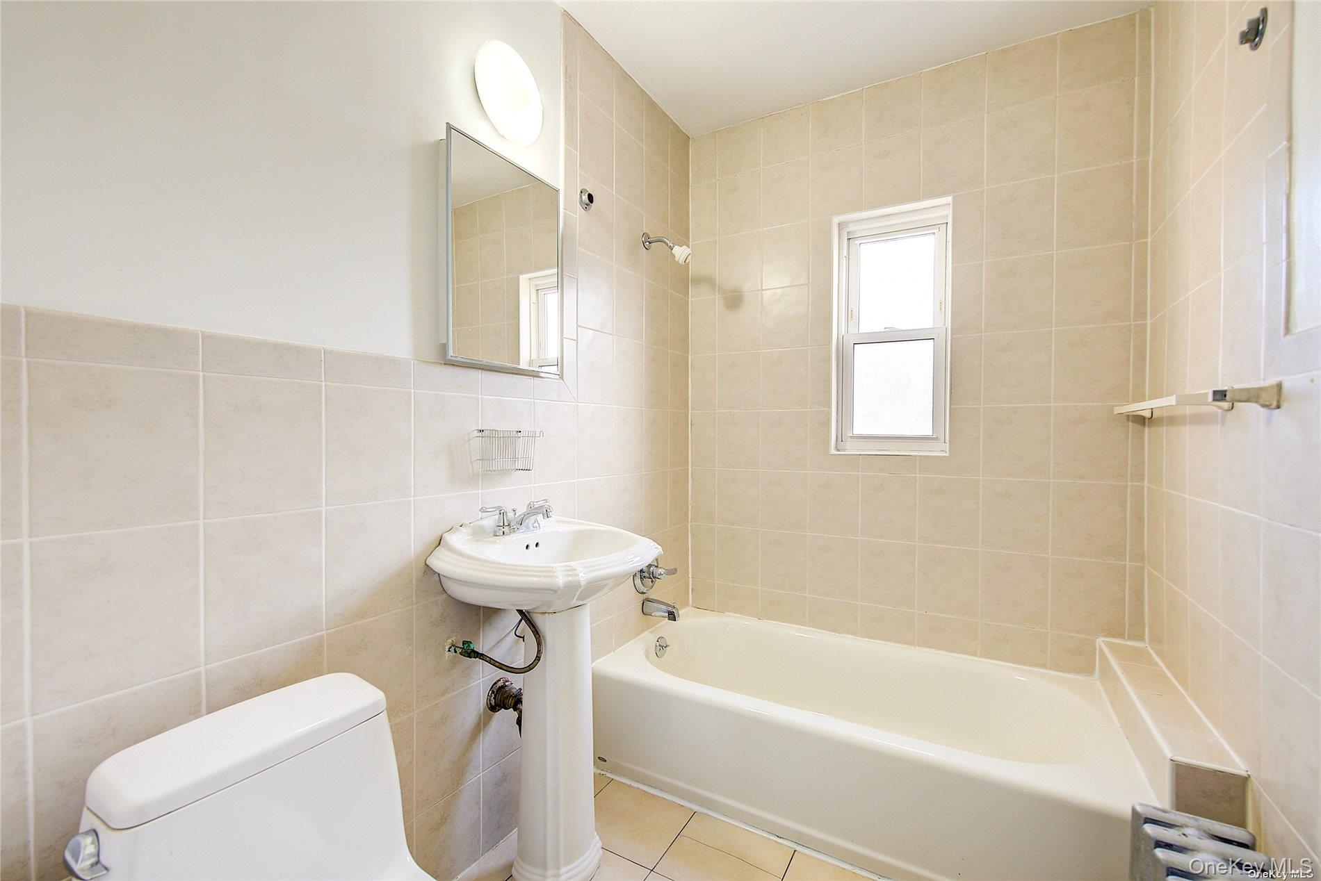 102-20 63rd Road Queens, NY 11375 - Photo 13 of 26 a bathroom with a sink a toilet and a bathtub