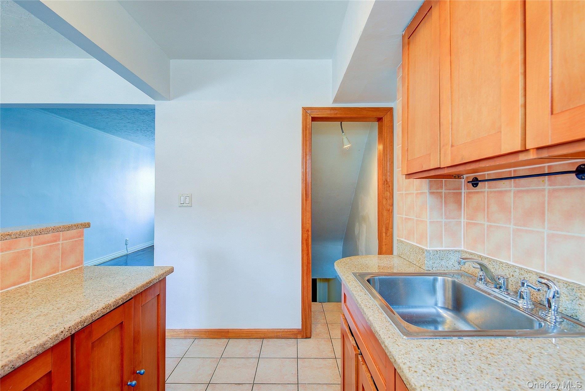 102-20 63rd Road Queens, NY 11375 - Photo 14 of 26 a kitchen with a sink and a refrigerator