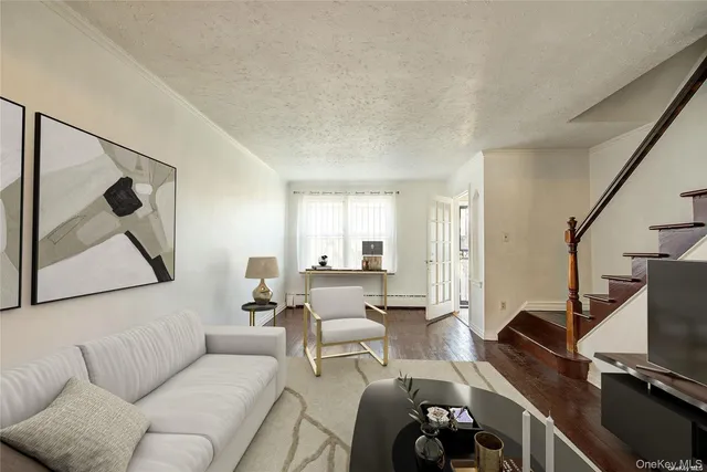 a living room with furniture a flat screen tv and a floor to ceiling window