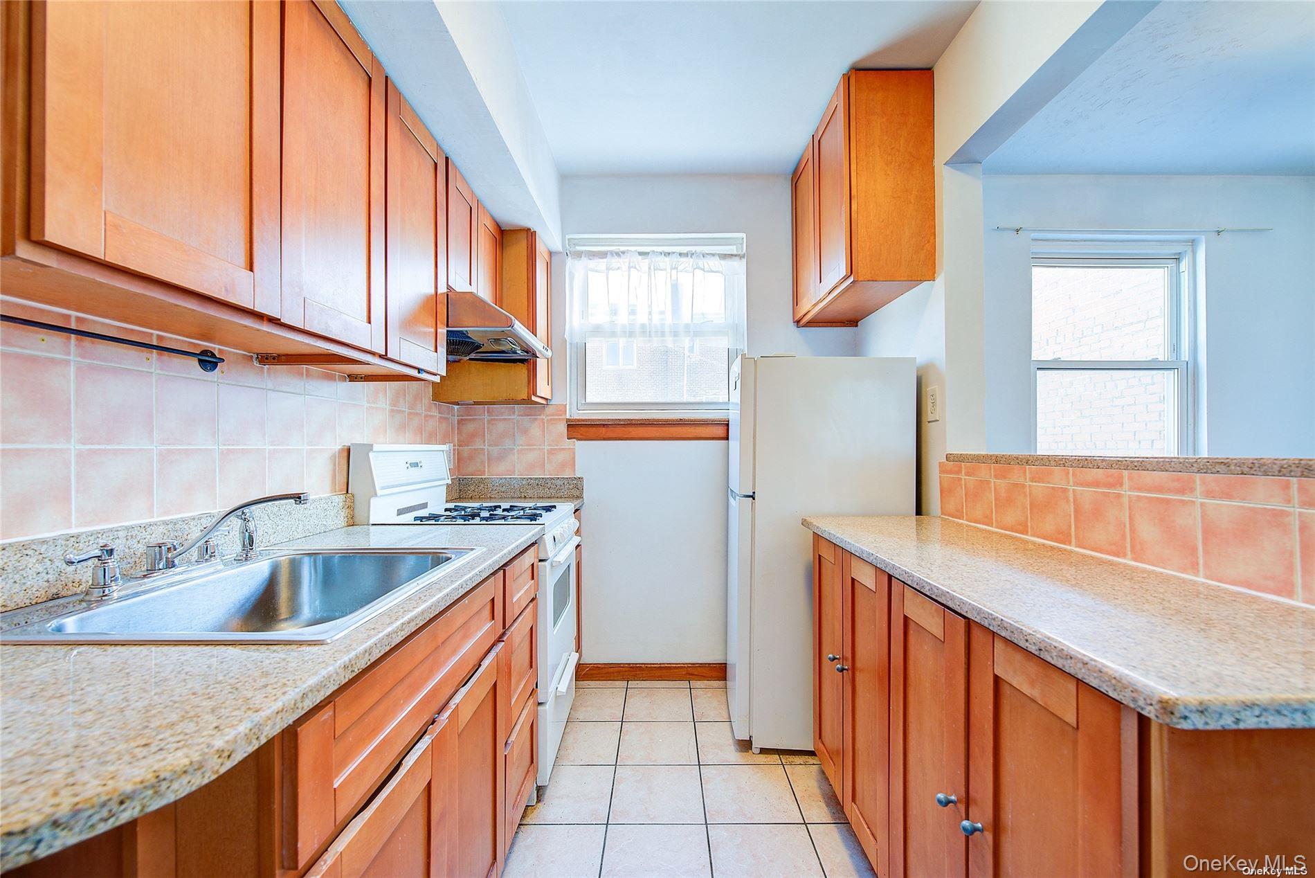 102-20 63rd Road Queens, NY 11375 - Photo 7 of 26 a kitchen with stainless steel appliances granite countertop a sink and a cabinets