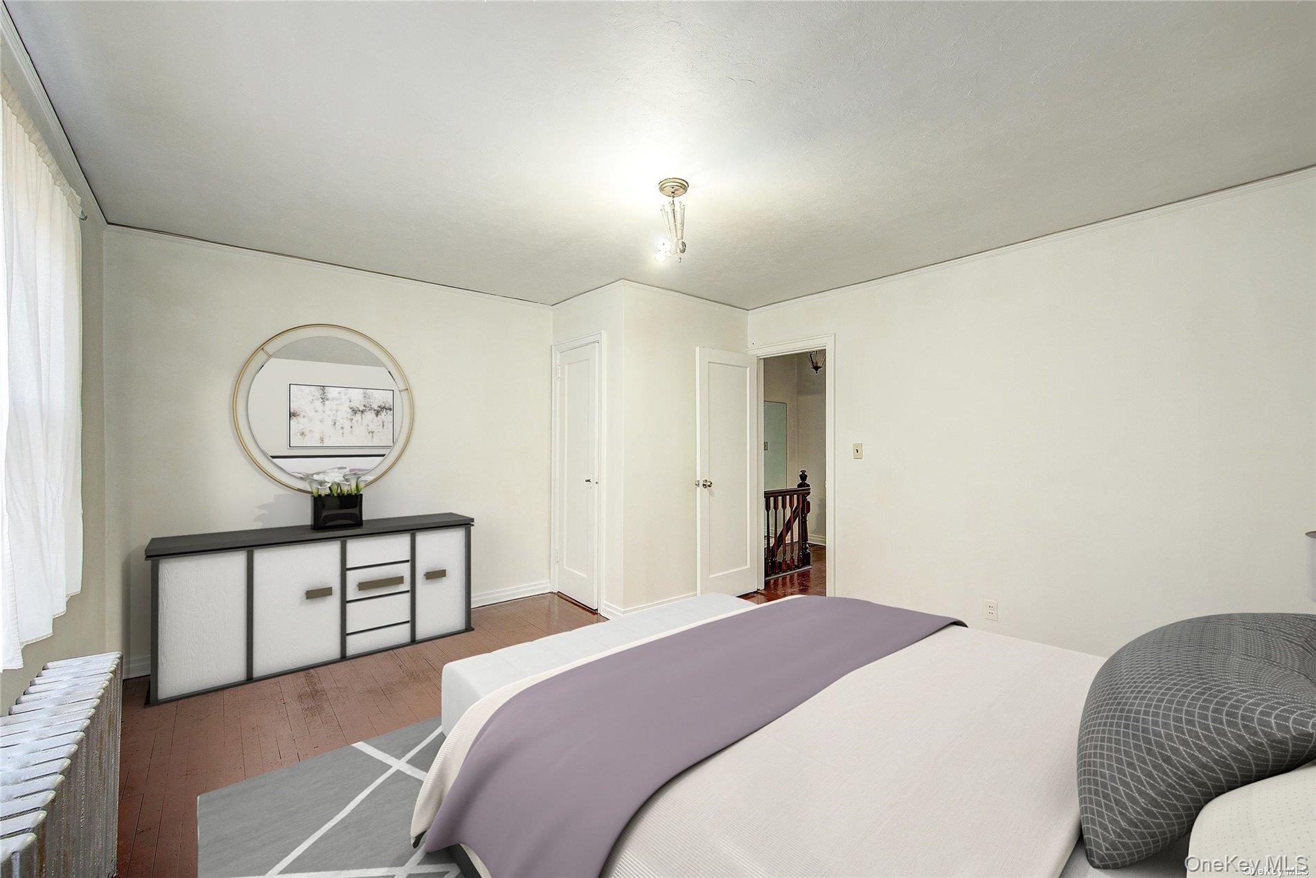 102-20 63rd Road Queens, NY 11375 - Photo 8 of 26 a bedroom with a bed a mirror and a window