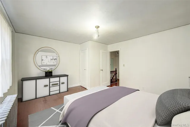 a bedroom with a large bed and a chandelier