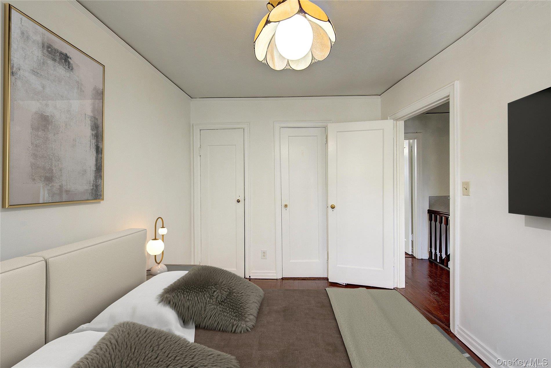 102-20 63rd Road Queens, NY 11375 - Photo 10 of 26 a bedroom with a bed and a flat tv screen on dresser