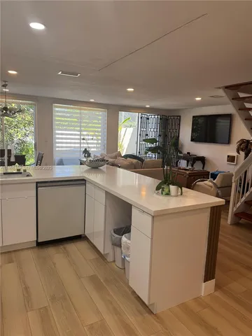 a kitchen with a sink a window a counter top space and stainless steel appliances