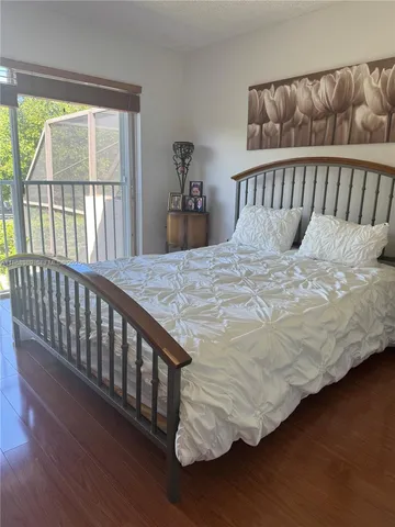 a bed sitting in a bedroom next to a window