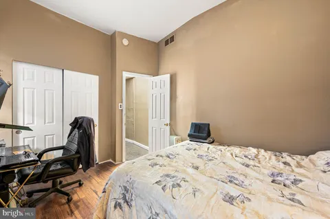 a bedroom with a bed and a large window