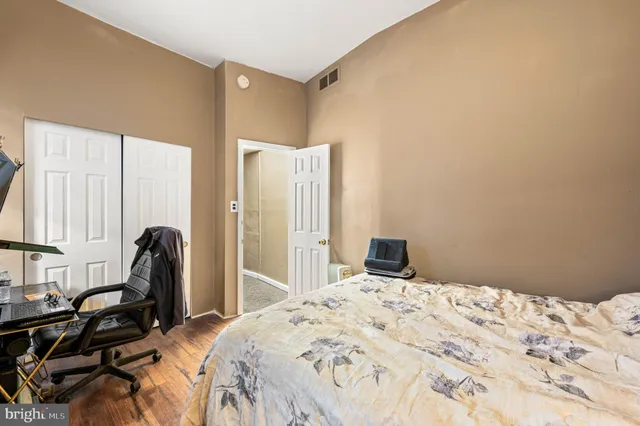 a bedroom with a bed and a large window