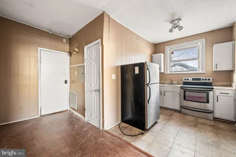 a kitchen with a refrigerator and a stove