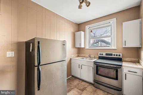 a kitchen with a refrigerator stove and sink