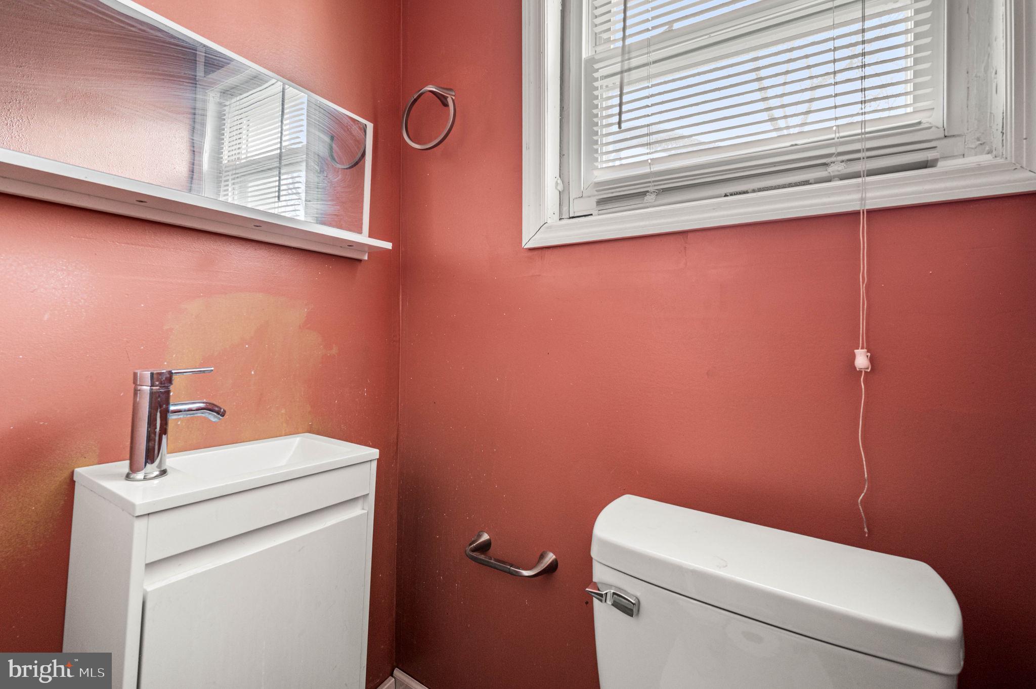 4925 Royal Street Philadelphia, PA 19144 - Photo 24 of 28 a bathroom with a toilet a sink and a window