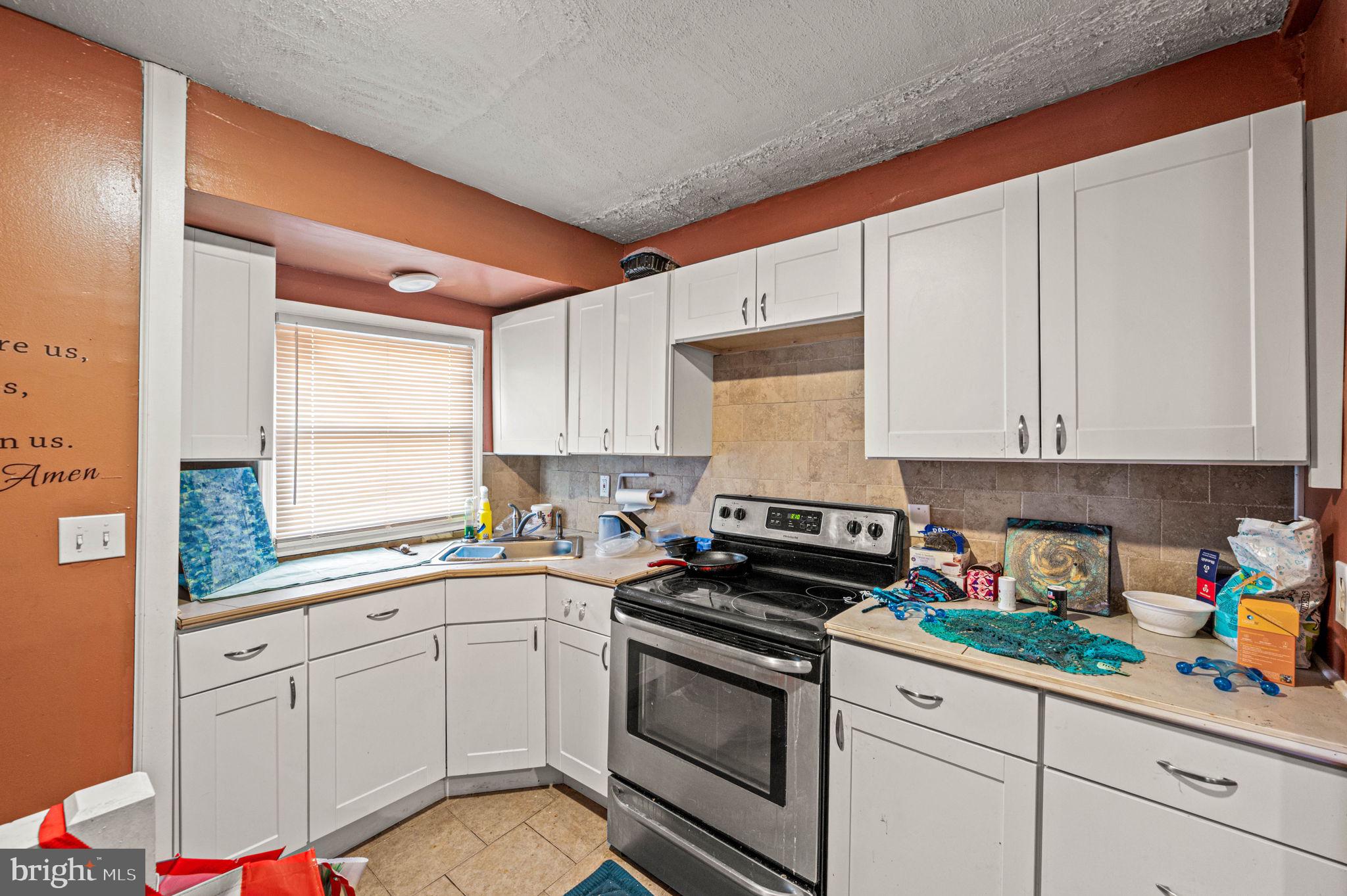 4925 Royal Street Philadelphia, PA 19144 - Photo 25 of 28 a kitchen with cabinets appliances a sink and a window