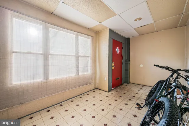 a view of a livingroom with wooden floor and windows