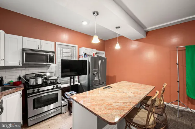 a kitchen with a stove and a microwave