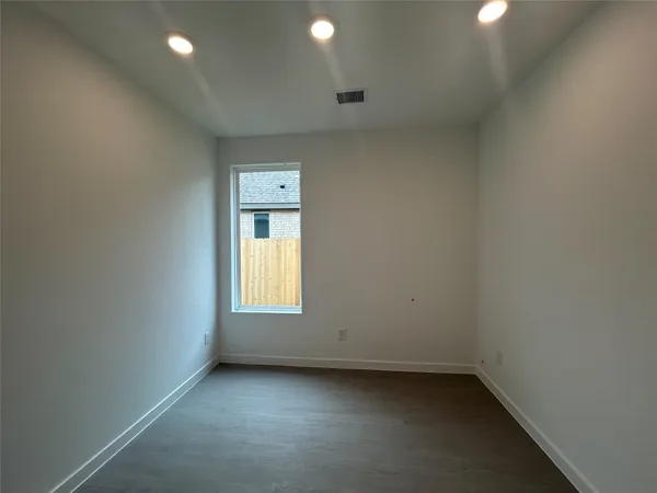 an empty room with a window and a fireplace