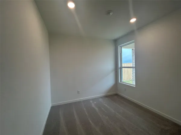 an empty room with a empty space and windows