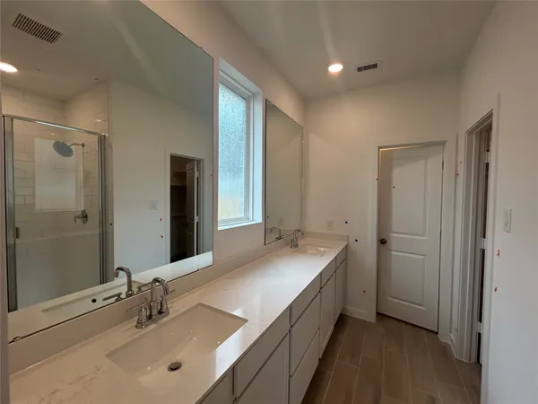 a bathroom with a double vanity sink mirror and double