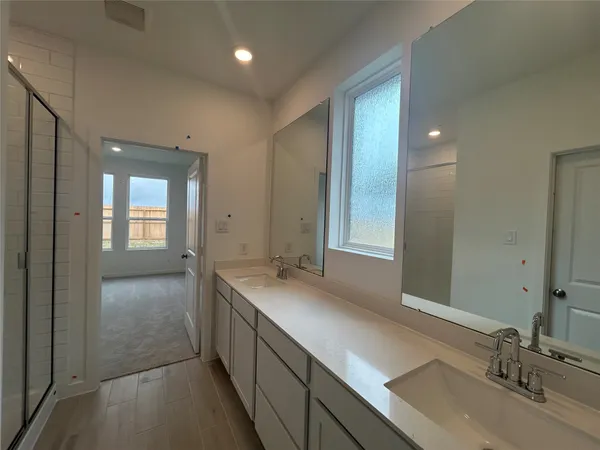 a bathroom with a sink double vanity and a mirror