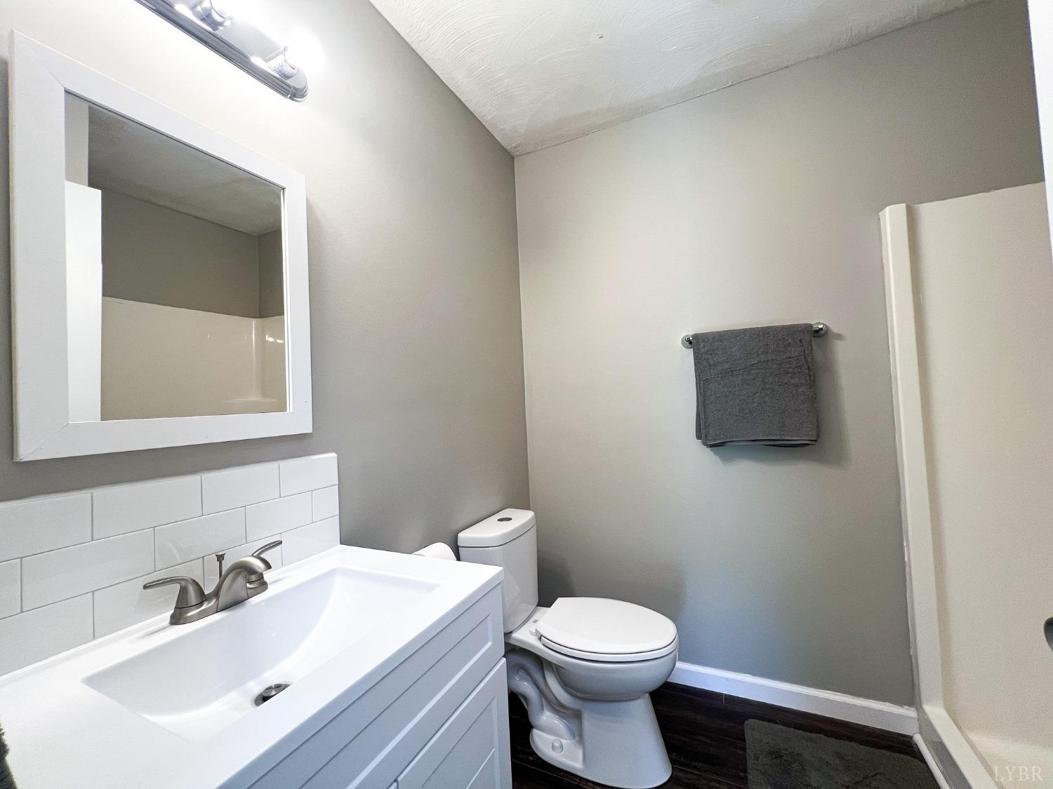 17 Phoebe Pond Road Concord, VA 24538 - Photo 9 of 19 a bathroom with a toilet a sink and mirror