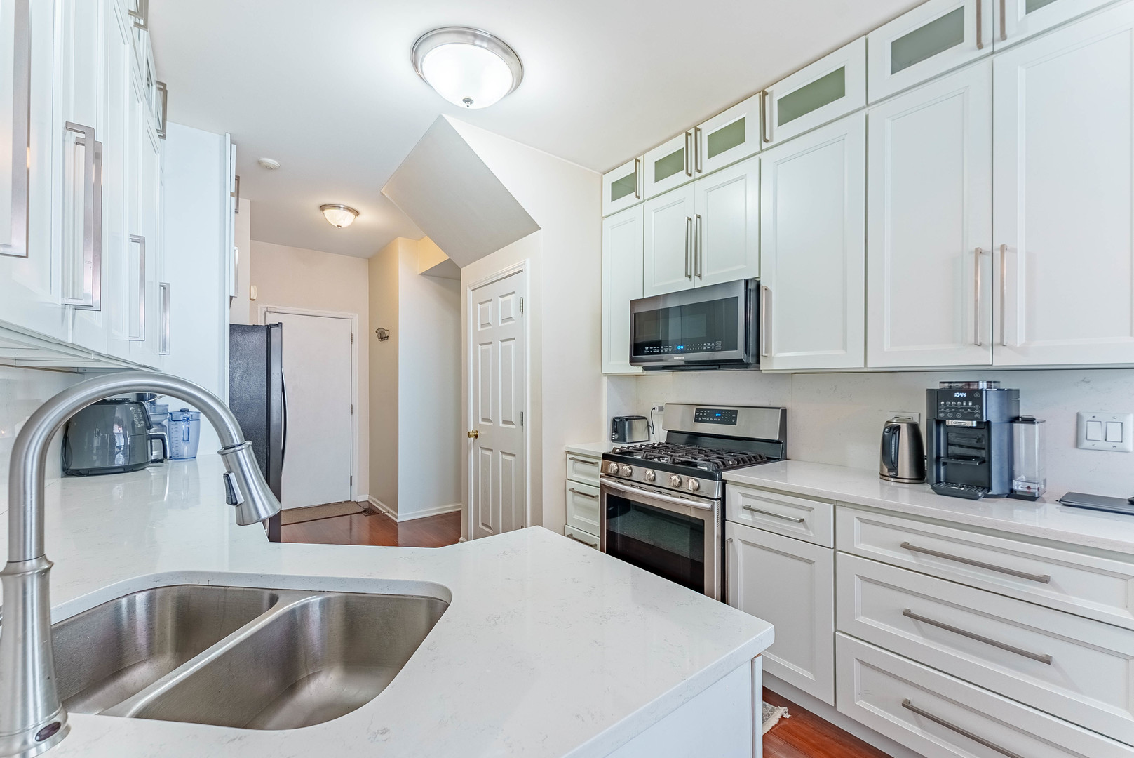 1748 Windward Avenue Naperville, IL 60563 - Photo 15 of 23 a kitchen with stainless steel appliances granite countertop a sink a stove and a refrigerator
