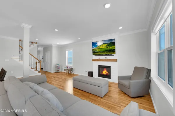 a view of a room with wooden floor stairs and a window