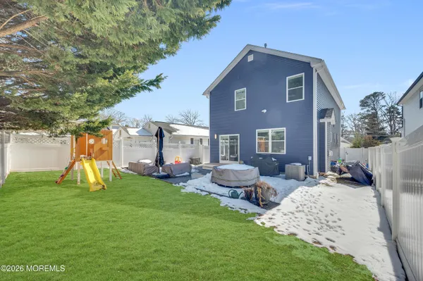 a front view of a house with garden and chairs