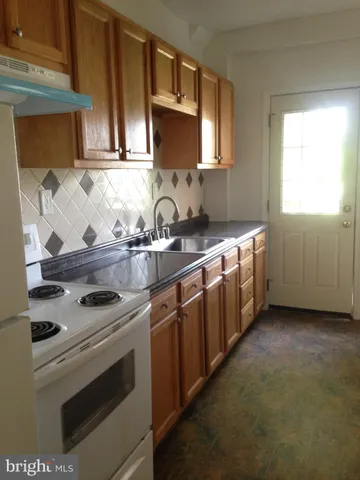 a kitchen with stainless steel appliances a stove a sink and a microwave