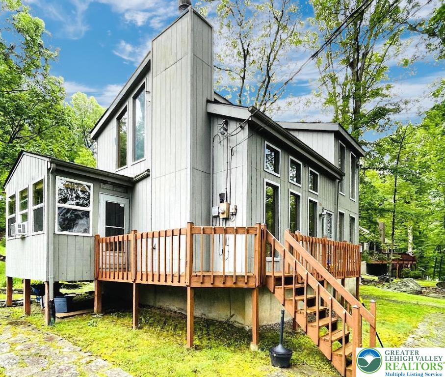 183 Radcliff Road Bushkill, PA 18324 - Photo 1 of 1 a backyard of a house with a garden and deck