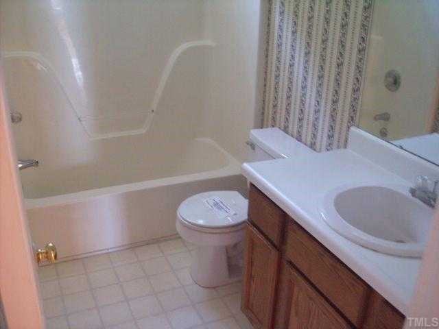 4817 Draper Road Raleigh, NC 27616 - Photo 5 of 5 a bathroom with a granite countertop sink a toilet and bathtub
