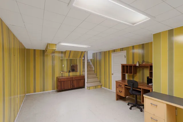 a view of workspace with furniture and window