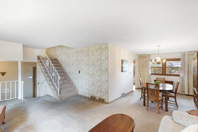 a view of a livingroom with furniture and staircase