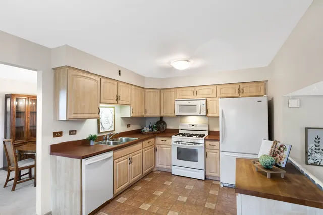 a kitchen with stainless steel appliances a refrigerator sink and stove