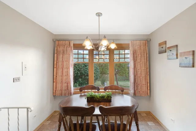 a view of a dining room with furniture window and outside view