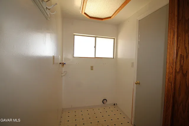 a bathroom with a window and a shower