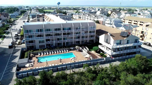 an aerial view of a house with a swimming pool and outdoor seating