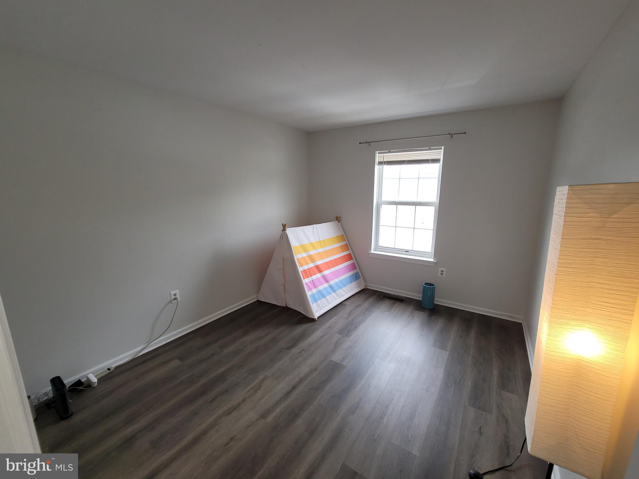2104 Harrison Court Eagleville, PA 19403 - Photo 17 of 22 an empty room with wooden floor and windows