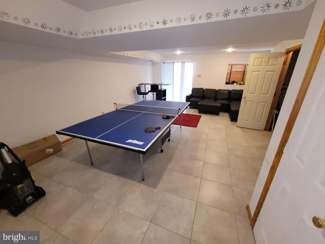 a living room with furniture a flat screen tv and a table