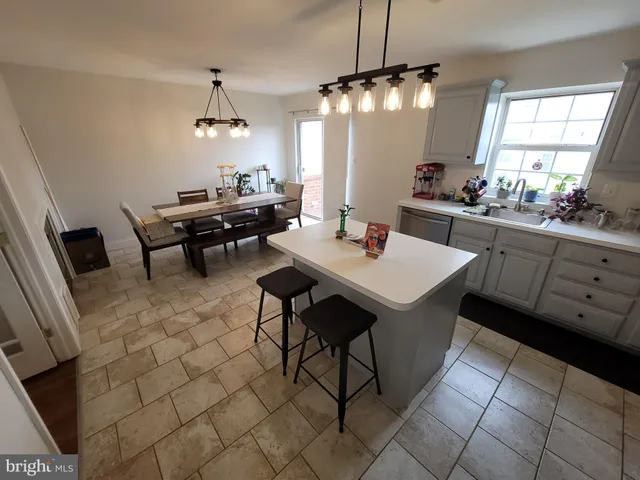 a kitchen with a dining table and chairs