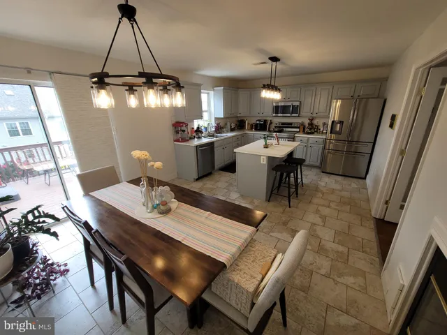 a dining room filled with furniture and a chandelier