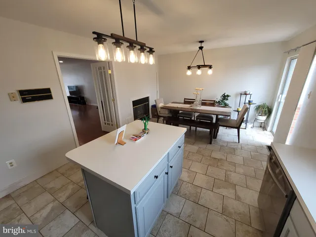 a kitchen with a table chairs and refrigerator