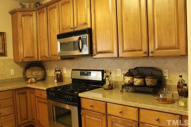 817 Stackhurst Way Wake Forest, NC 27587 - Photo 4 of 23 Upgrades GALORE! 42 inch Glazed Cabinets, Silestone Countertops, and Stainless Steel Appliances!